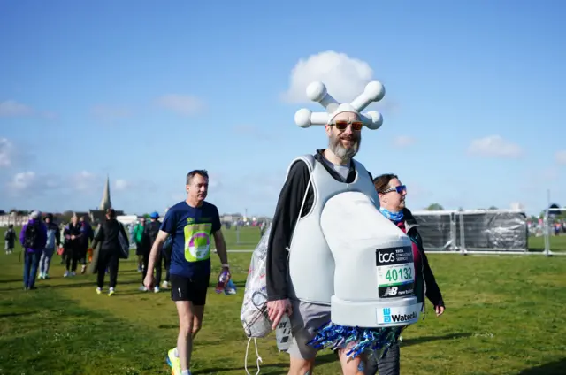 A competitor dressed as a tap before the TCS London Marathon.