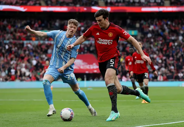 Victor Torp of Coventry City battles for possession with Harry Maguire