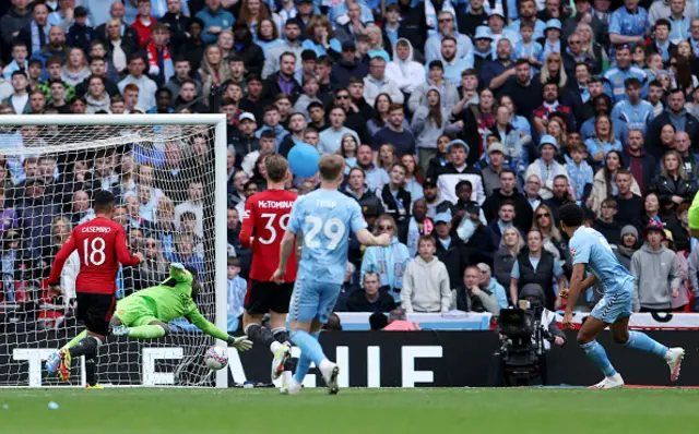 Ellis Simms of Coventry City scores his team's first goal past Andre Onana