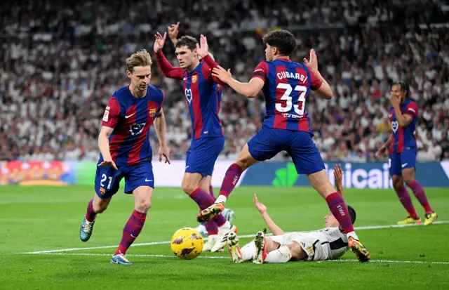 Lucas Vazquez of Real Madrid is fouled by Pau Cubarsi