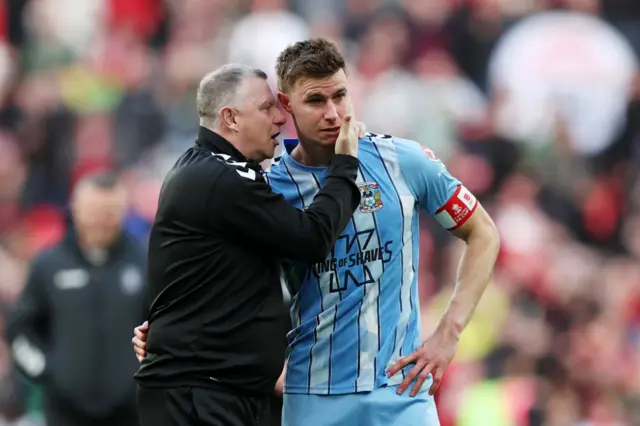 Coventry manager Mark Robins consoles Ben Sheaf