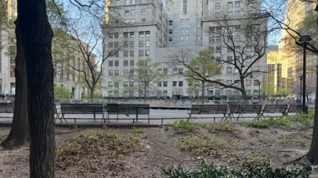 An empty park outside a New York courthouse