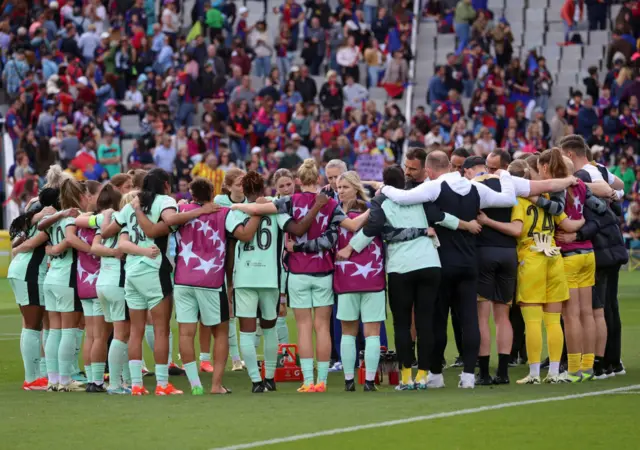 Emma Hayes gives a team talk to her Chelsea players in Barcelona