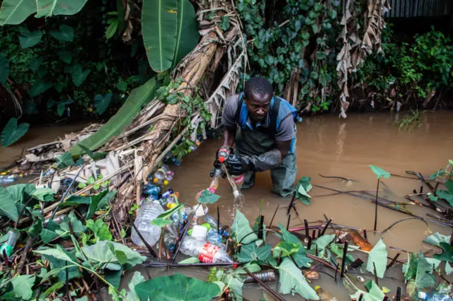 A volunteer clears up plastic waste in 2015.