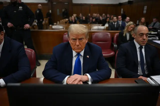 Donald Trump sits in court