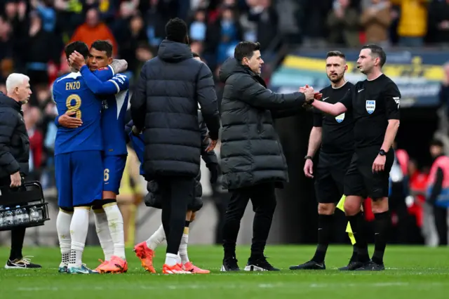 Chelsea players hug each other at the final whistle as Mauricio Pochettino shakes the hand of the referee following Chelsea's defeat to Manchester City at Wembley