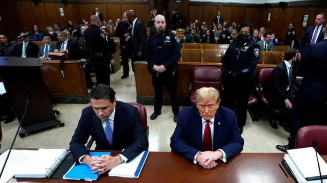 Donald Trump sits in court