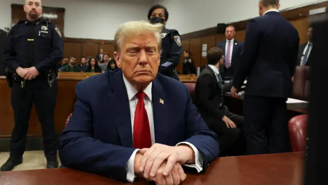 Donald Trump sits in court