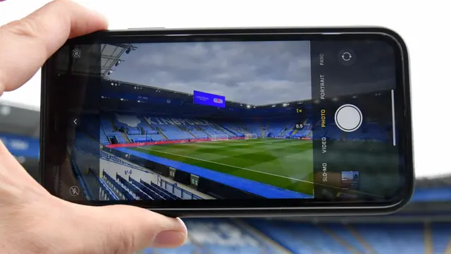 Person taking a picture of the King Power Stadium