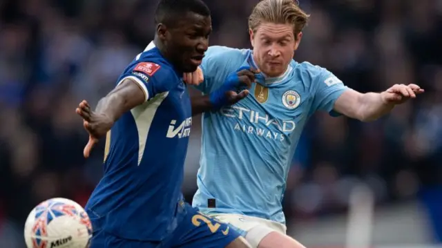 Chelsea and Manchester City players battle for the ball