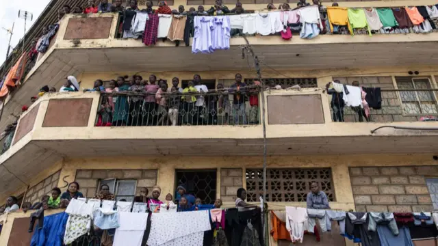 Stranded residents of Mathare slum, look on from their balconies following heavy down pour in the capital, Nairobi on April 24, 2024.