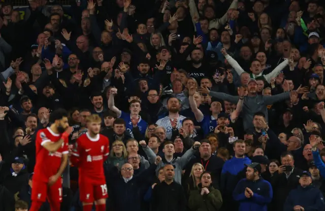 Fans celebrate as Liverpool playrrs look crestfallen