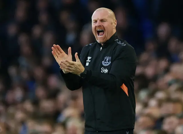 Dyche claps and shouts encouragement from the touchline