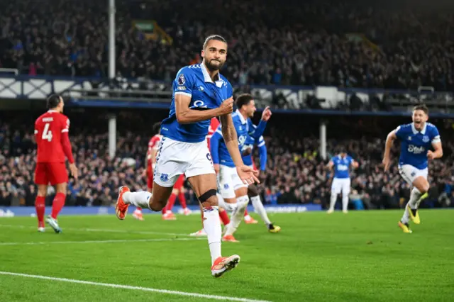 Calvert-Lewin celebrates his goal by grabbing the badge on his chest