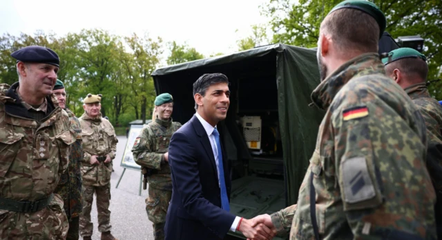 Prime Minister Rishi Sunak shakes hands with soldiers of the German armed forces Bundeswehr as he visits the Julius Leber Barracks in Berlin