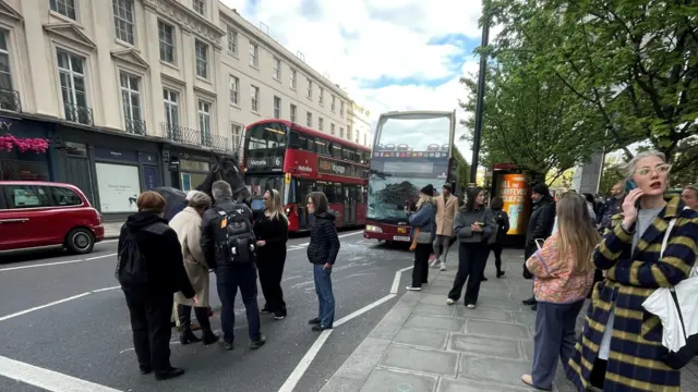 People with a horse on a London road.