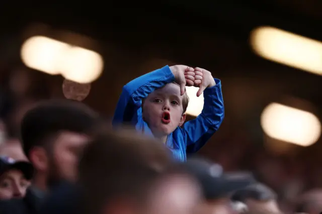 A young fan puts both thumbs down after Everton do not get a call