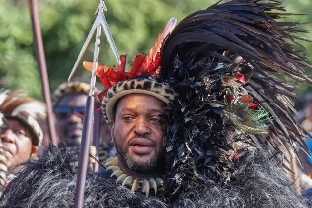 King of Amazulu nation Misuzulu kaZwelithini (C) holds a spear as he sings with Amabutho (Zulu regiments) during his coronation at the KwaKhangelamankengane Royal Palace in Kwa-Nongoma 300km north of Durban on August 20, 2022.