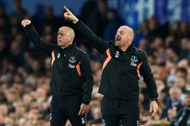 Duche points and shouts instructions from the touchline