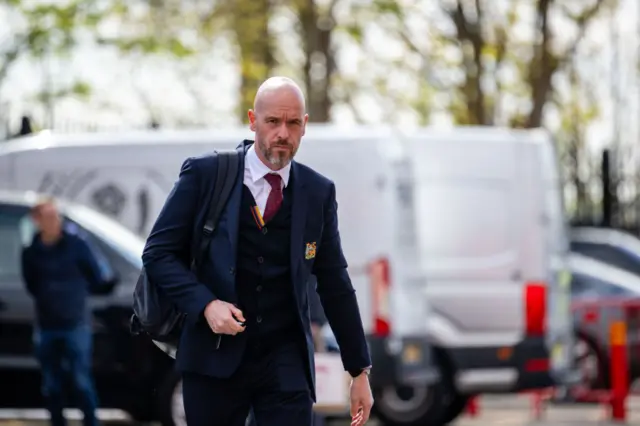 Ten Hag walks into old trafford with a rucksack on his back