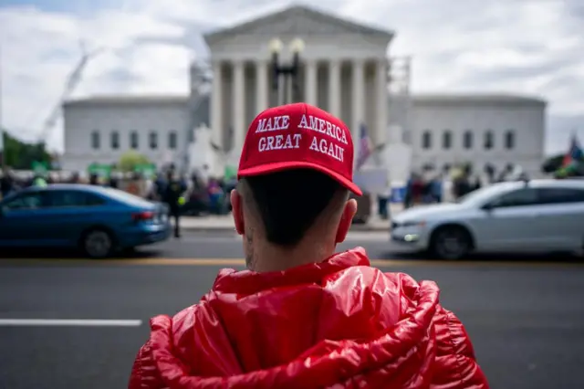 Man wearing Make America Great Again cap