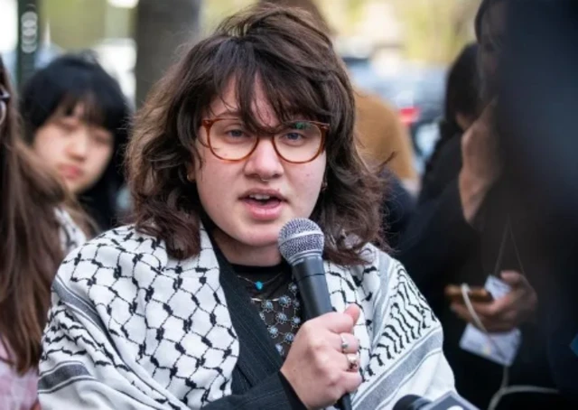 A woman speaking into a microphone