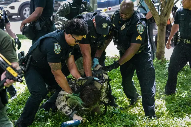 Police detain a protester at Emory University