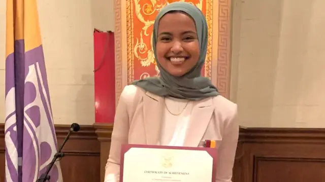 Student Asna Tabassum holds a certificate at the USC's Academic Honors Convocation.