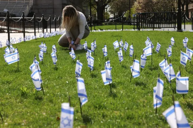 A student places an Israeli flag near the main lawn of Columbia University,