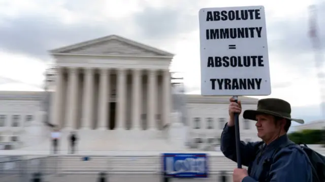 A demonstrator holds a sign outside the US Supreme Court in Washington, DC, US, on Thursday, April 25, 2024.