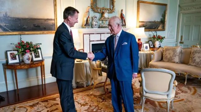 King and Jeremy Hunt shaking hands