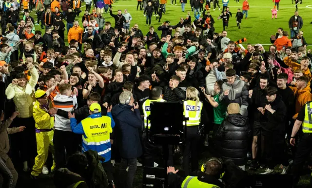 Dundee United fans invade the pitch as they win the cinch Championship title during a cinch Championship match between Airdrionians and Dundee United at Excelsior Stadium, on April 26, 2024, in Airdrie, Scotland.