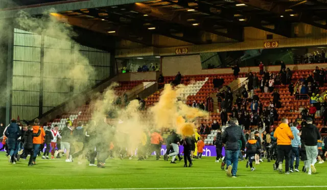 Dundee United fans invade the pitch as they win the cinch Championship title during a cinch Championship match between Airdrionians and Dundee United at Excelsior Stadium, on April 26, 2024, in Airdrie, Scotland.