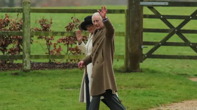 King Charles and Queen Camilla walking in countryside