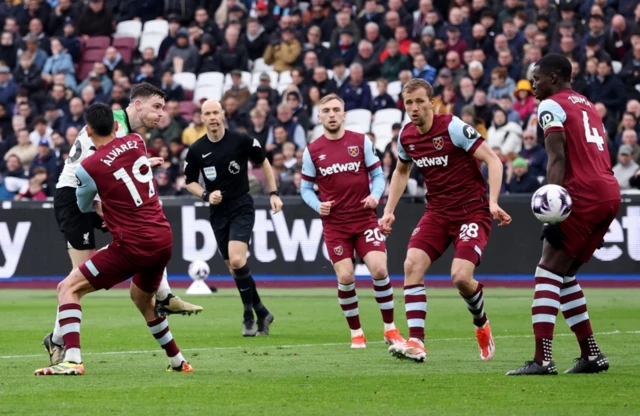 Andy Robertson shoots at goal as Kurt Zouma attempts to block it