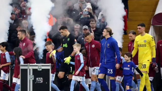 Teams take the pitch before the match