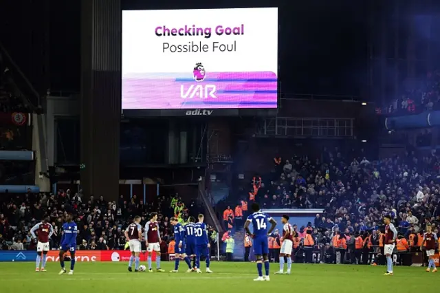 Players wait for referee Craig Pawson to check the VAR before disallowing the goal