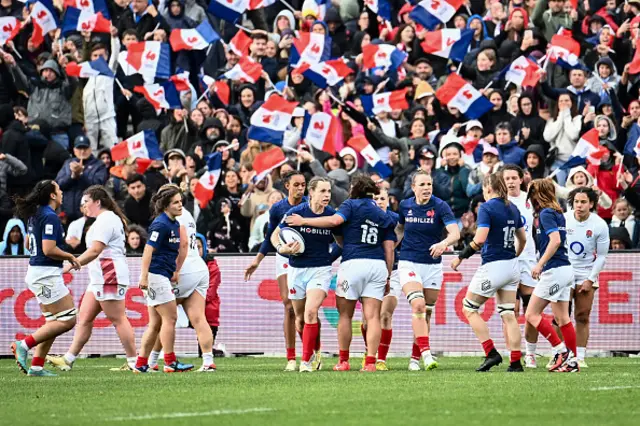 Marine Menager (C) celebrates after scoring the team's third try