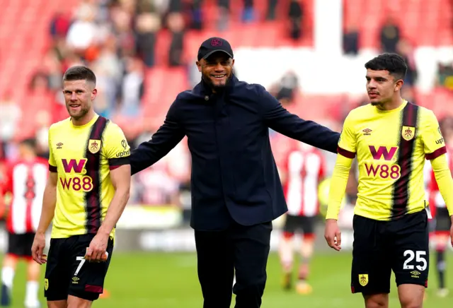 Kompay, Gudmundsson and Amdouni chat on the pitch at full time