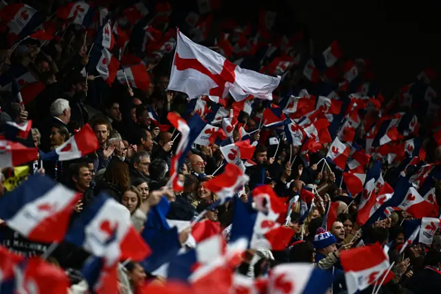 England's supporters wave an English flag in the middle of France's supporters