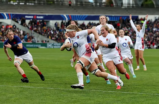 Alex Matthews of England breaks through to score her team's sixth try