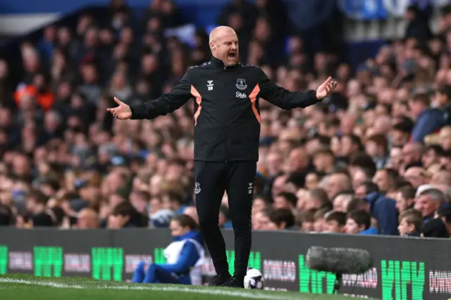 Dyche waves her arms in the air