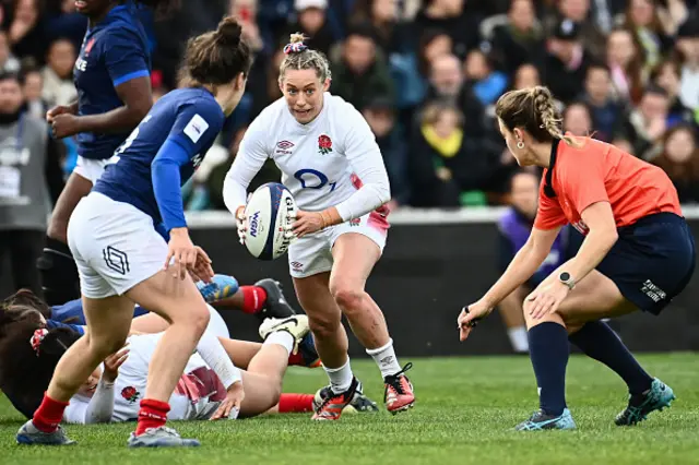 Natasha Hunt (C) runs with the ball