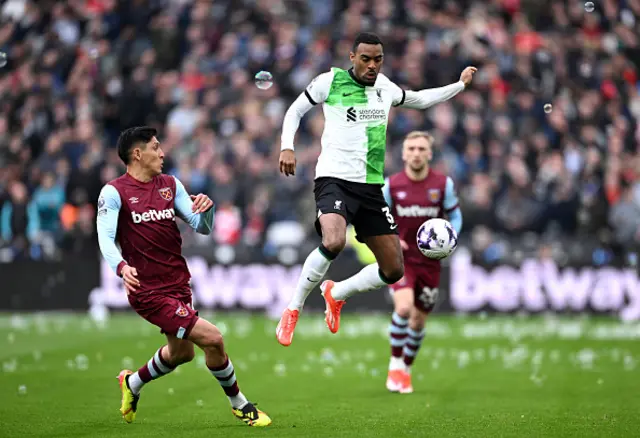 Ryan Gravenberch of Liverpool chases a loose ball under pressure from Edson Alvarez