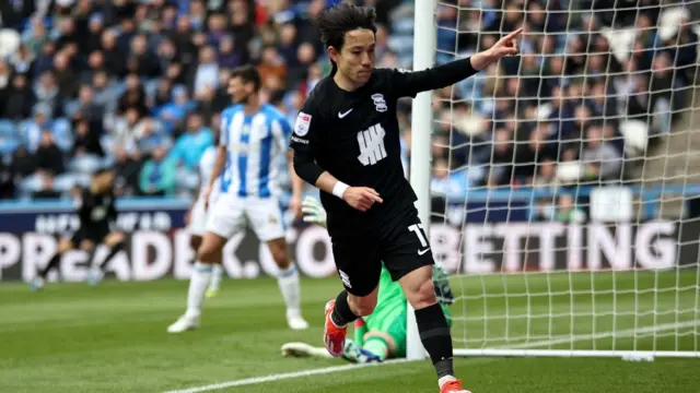 Koji Miyoshi celebrates scoring