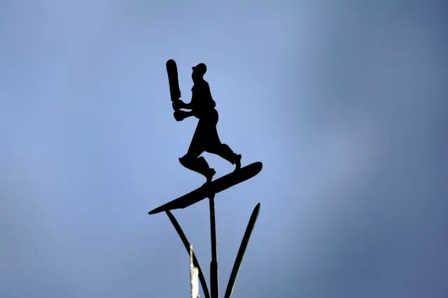 Figure of cricketer on a wind dial