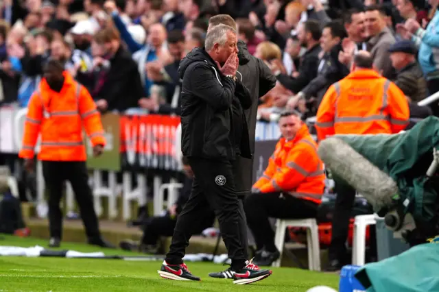 Wilder puts his hands to his mouth in disbelief