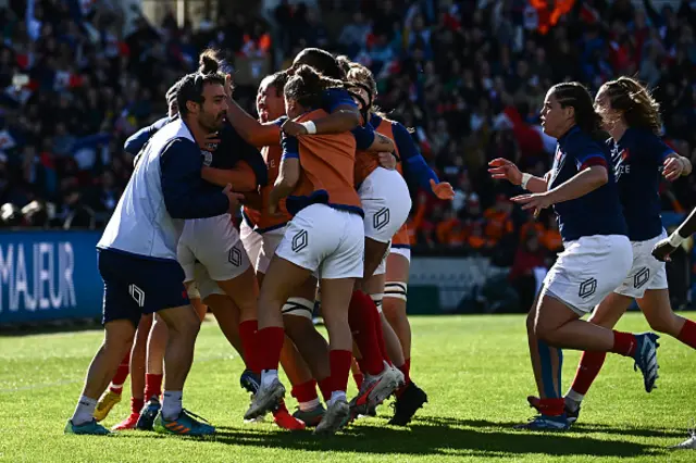 France's players celebrate after scoring the team's first try