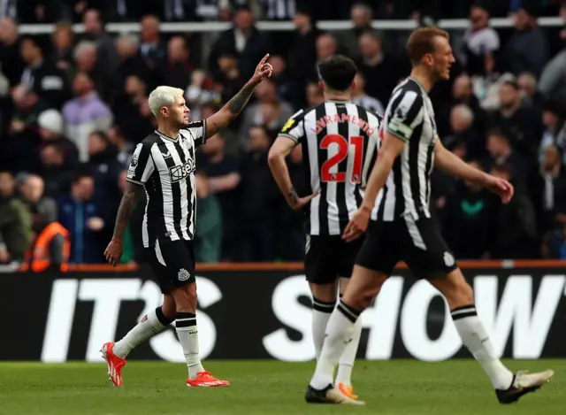 Guimaraes poinits to the crowd after his goal