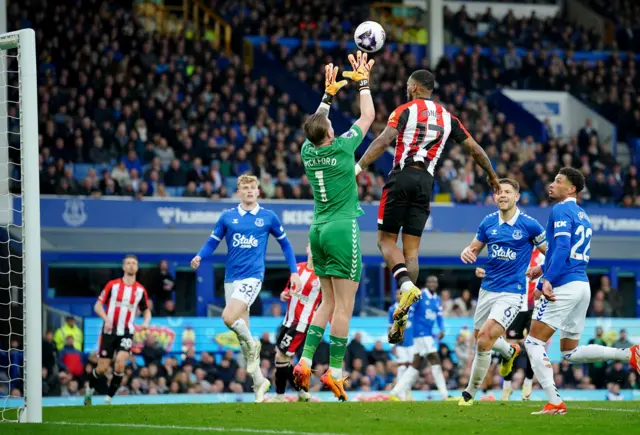 Pickford catches the ball in a packed penalty area